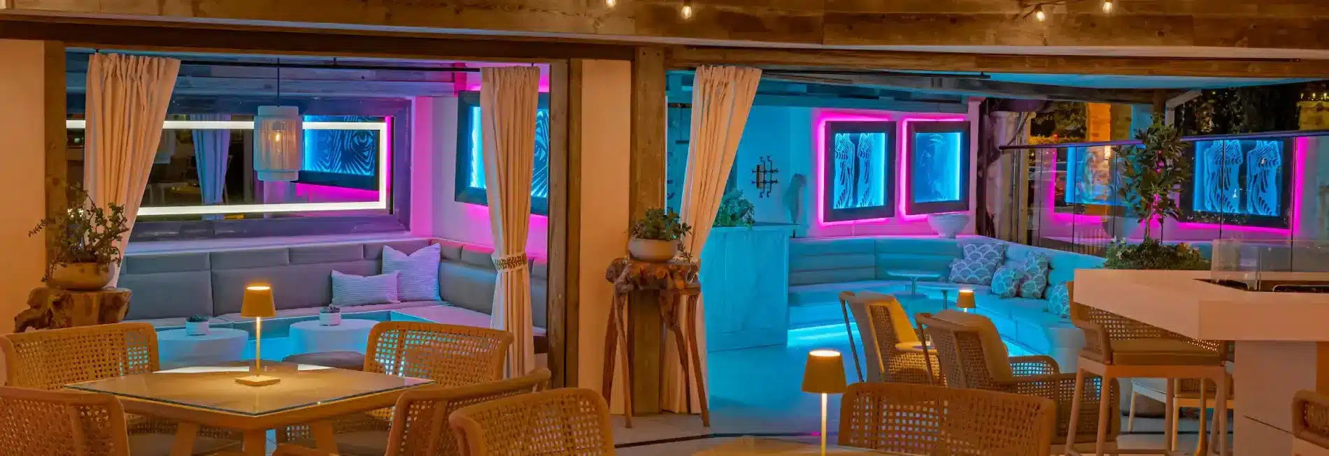 Neon-lit lounge seating at Club Louie's after dark